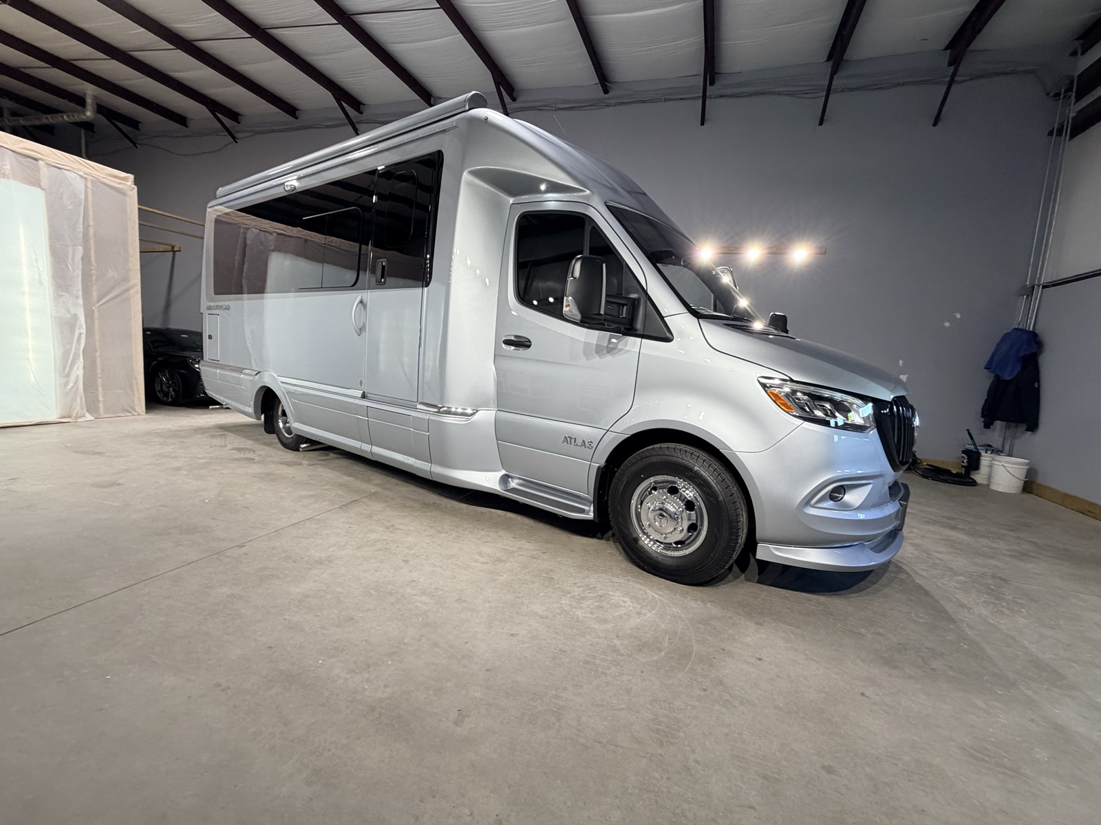 Silver Airstream Atlas touring coach with window tint