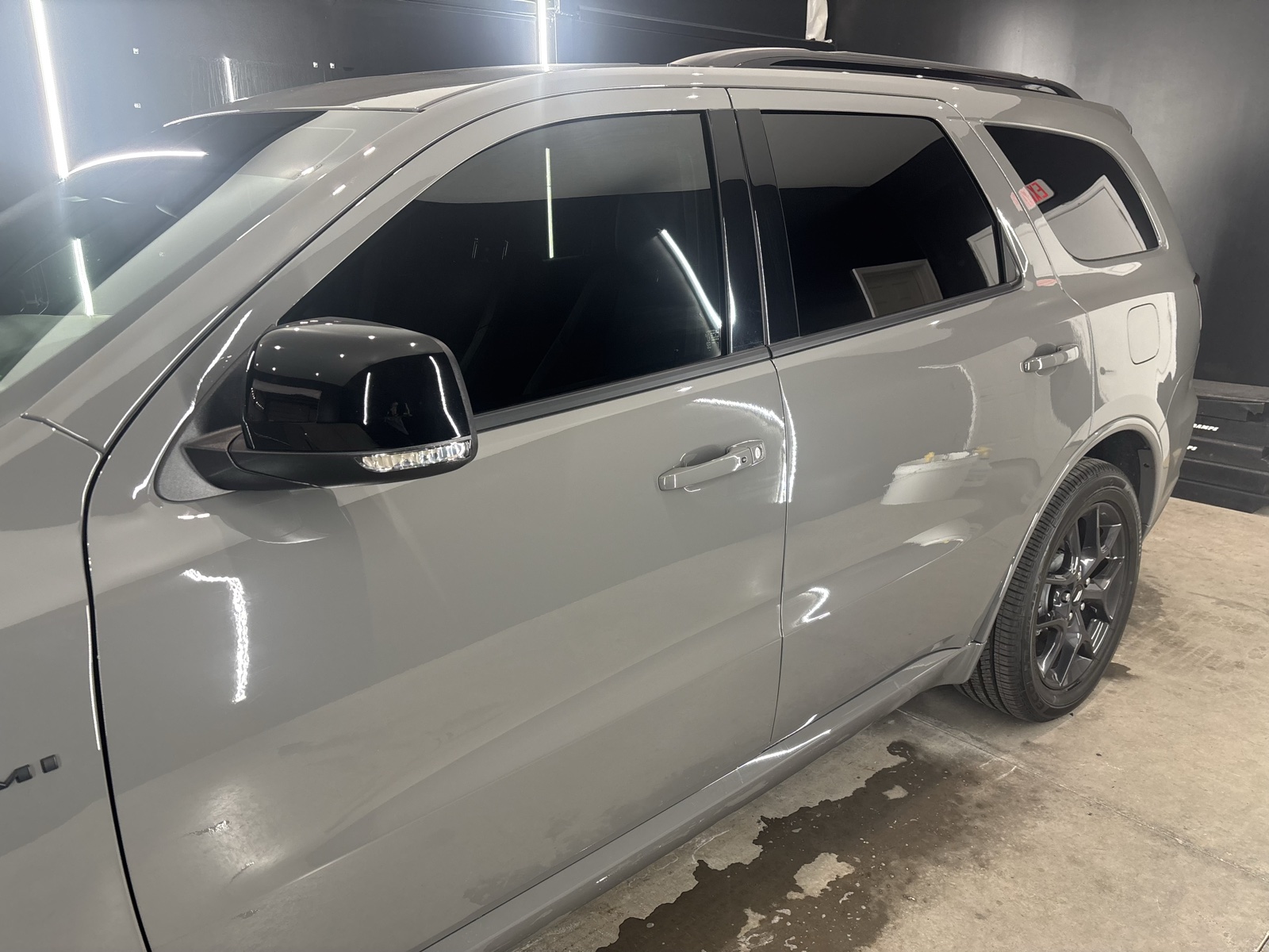 Gray Dodge Durango with dark window tint in the Coastal Details shop